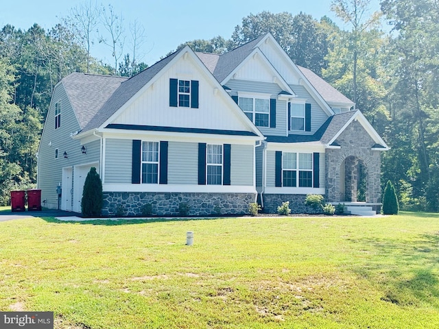 craftsman inspired home featuring a garage and a front yard