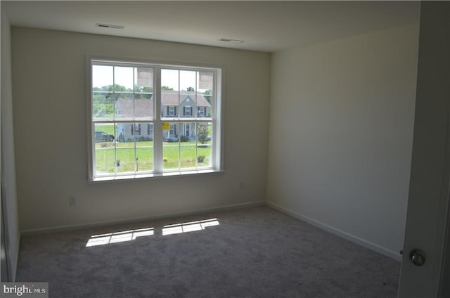 empty room featuring dark colored carpet