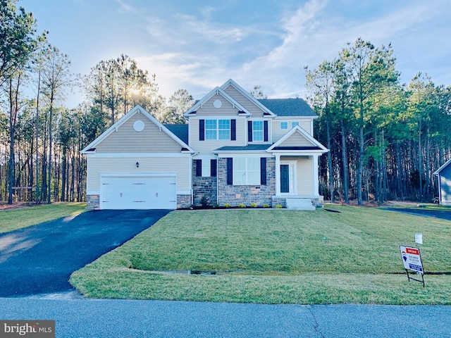 view of front of house with a garage and a front lawn