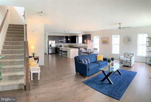 living room featuring ceiling fan and hardwood / wood-style flooring