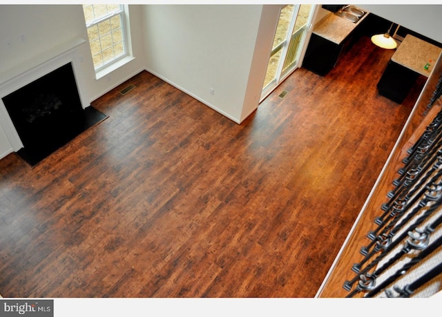 unfurnished living room with dark wood-type flooring