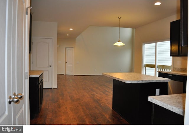 kitchen with a center island, decorative light fixtures, stainless steel dishwasher, and dark hardwood / wood-style floors