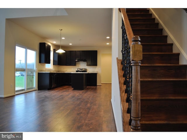 kitchen featuring decorative light fixtures and dark hardwood / wood-style floors