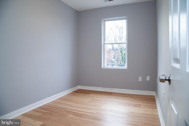 unfurnished room featuring light wood-type flooring and baseboards