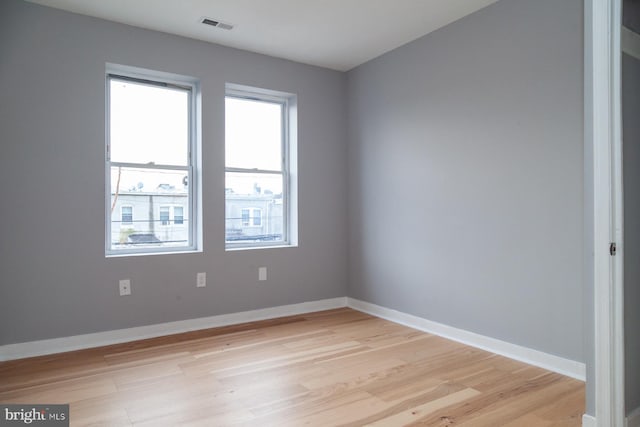 empty room with healthy amount of natural light and light wood-type flooring