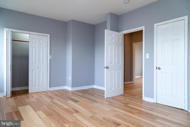 unfurnished bedroom featuring light wood finished floors and baseboards