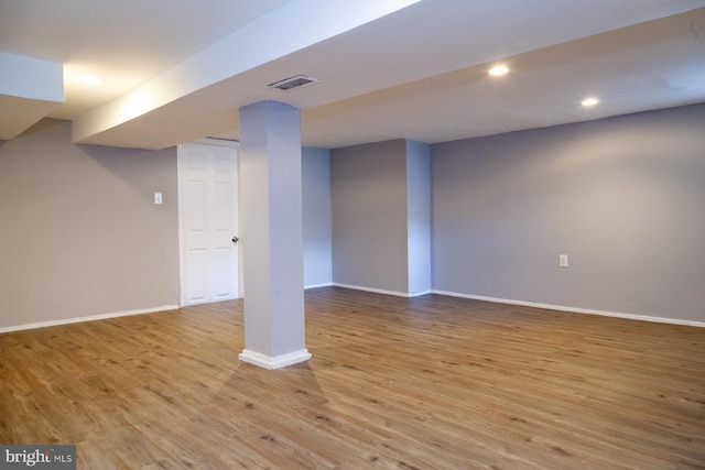 finished basement with light wood finished floors and recessed lighting