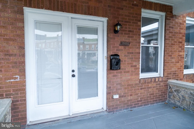 doorway to property with brick siding