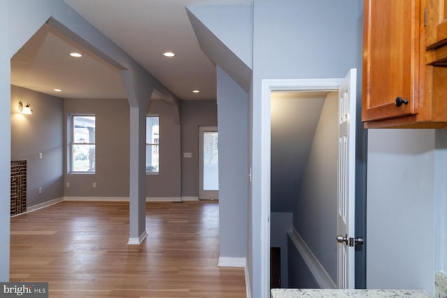interior space featuring wood finished floors, recessed lighting, and arched walkways