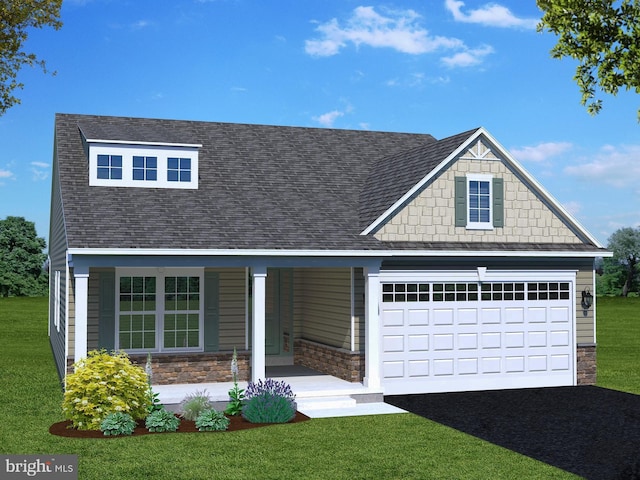 craftsman-style house featuring covered porch, a garage, and a front yard