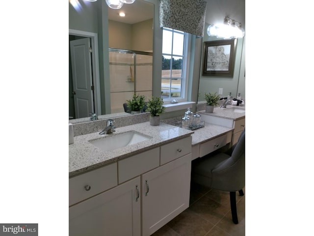 bathroom with tile patterned flooring, vanity, and a shower with shower door