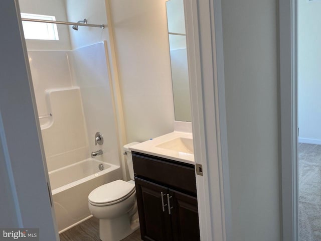 full bathroom with hardwood / wood-style floors, vanity, toilet, and shower / tub combination