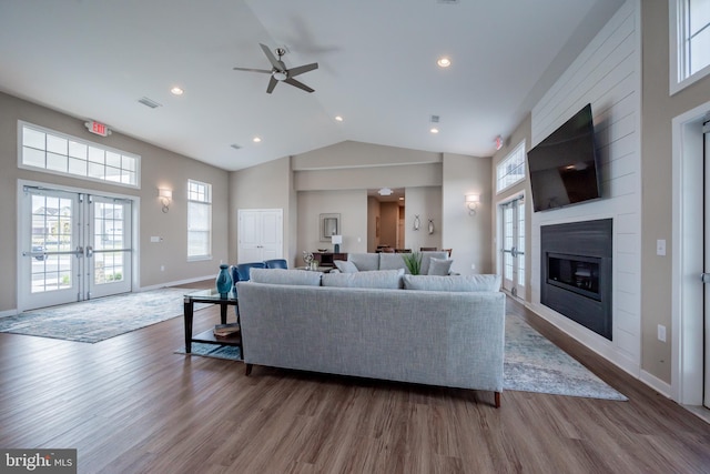 living room featuring wood-type flooring, french doors, high vaulted ceiling, and ceiling fan