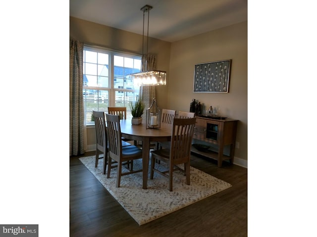 dining area with dark hardwood / wood-style floors