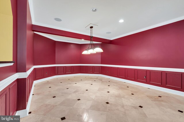 spare room with light tile patterned floors and crown molding