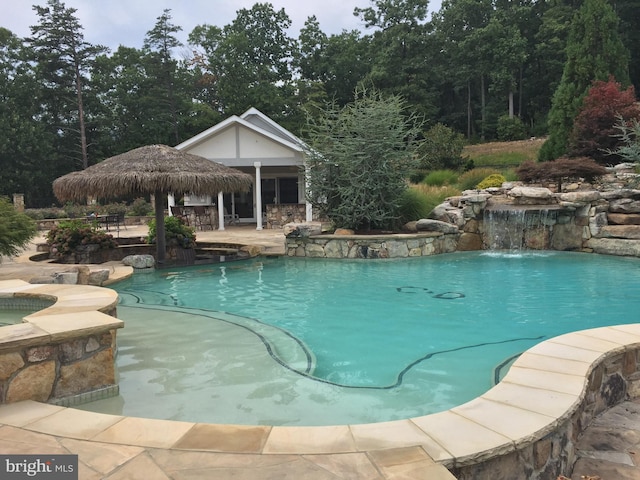 view of swimming pool featuring pool water feature and a gazebo