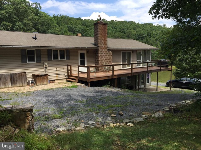 back of house featuring a wooden deck