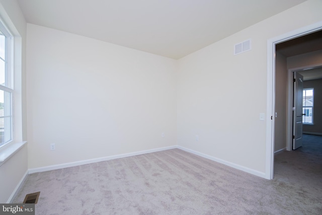 unfurnished room with light colored carpet