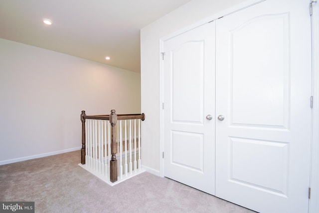 corridor with light carpet