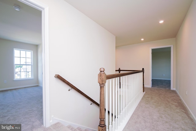 hallway with light carpet