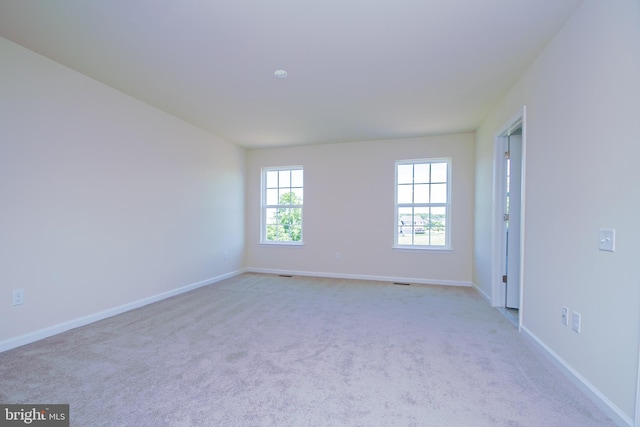 unfurnished room featuring light colored carpet