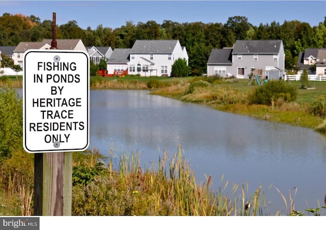 community / neighborhood sign featuring a water view