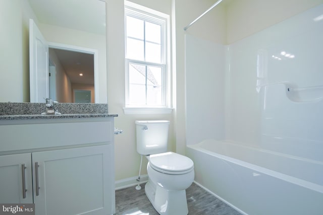 full bathroom with a wealth of natural light, bathtub / shower combination, toilet, and large vanity