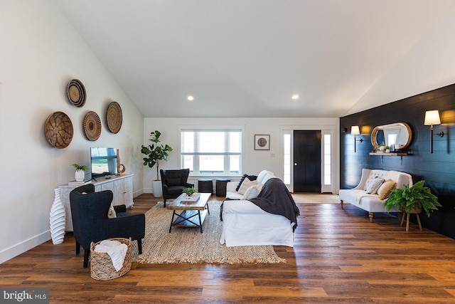 living room with dark hardwood / wood-style floors and lofted ceiling