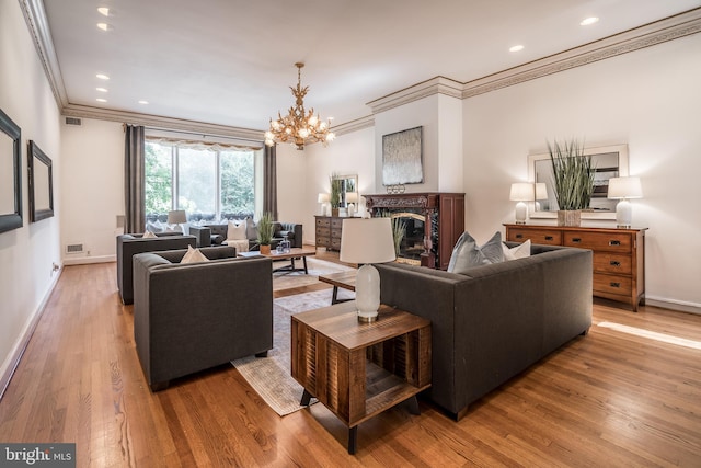 living room featuring a chandelier, wood-type flooring, ornamental molding, and a premium fireplace