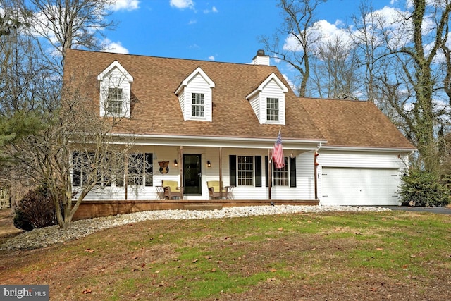 cape cod house with a chimney, roof with shingles, covered porch, a front lawn, and a garage