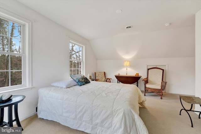 bedroom with visible vents, carpet floors, and vaulted ceiling