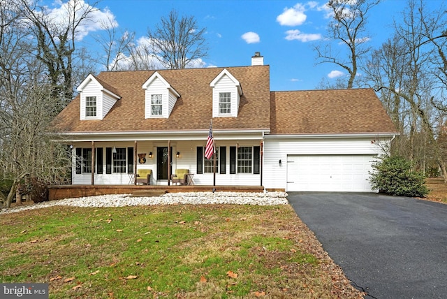 new england style home featuring a chimney, a porch, aphalt driveway, a garage, and roof with shingles