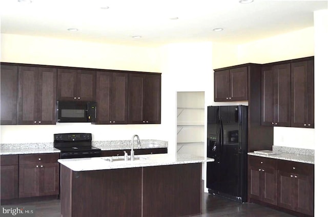 kitchen with sink, an island with sink, black appliances, and dark hardwood / wood-style floors