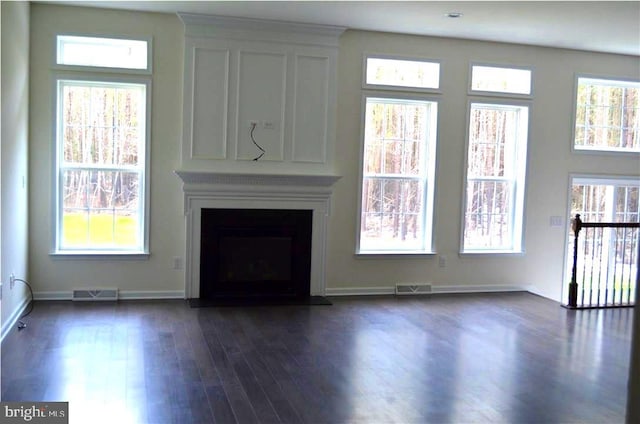 unfurnished living room with dark hardwood / wood-style floors