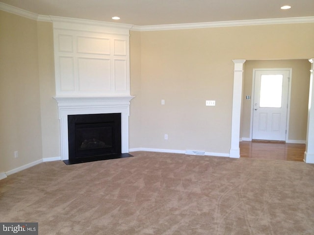 unfurnished living room featuring ornamental molding and carpet