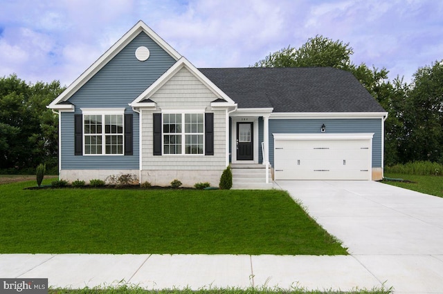 view of front of house featuring a front yard and a garage