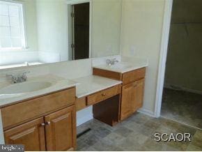 bathroom with vanity and tile patterned flooring