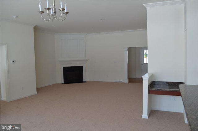 unfurnished living room with a notable chandelier, ornamental molding, and light colored carpet