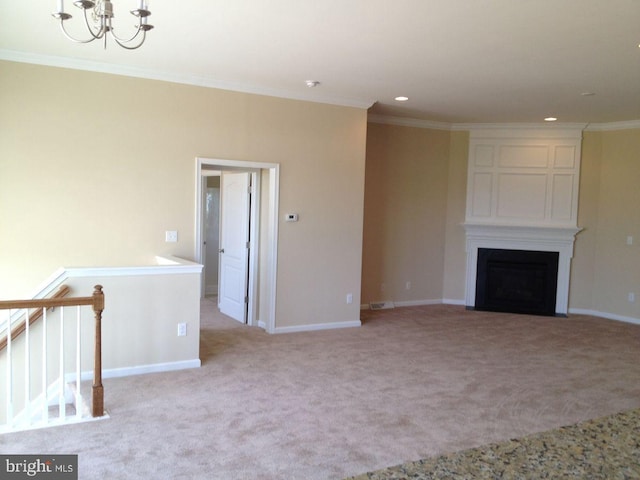 unfurnished living room featuring crown molding, light colored carpet, and an inviting chandelier