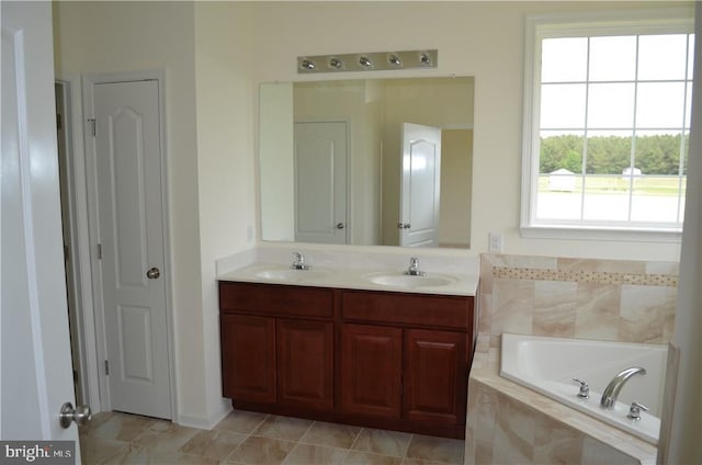 bathroom featuring vanity and tiled bath