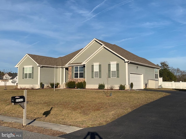 ranch-style home with a front yard and a garage