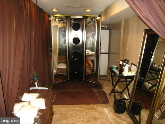 clothes washing area featuring stacked washer / drying machine