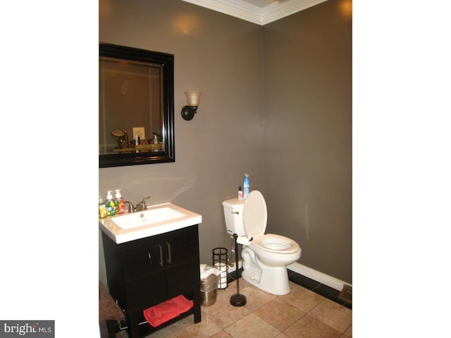 bathroom featuring tile patterned flooring, vanity, toilet, and ornamental molding