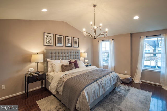 bedroom with an inviting chandelier, vaulted ceiling, and dark hardwood / wood-style flooring