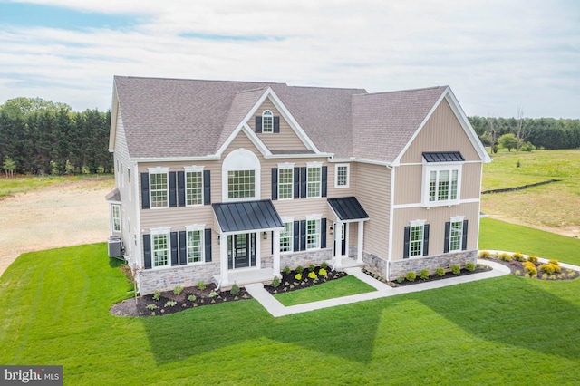 view of front of home with central air condition unit and a front lawn