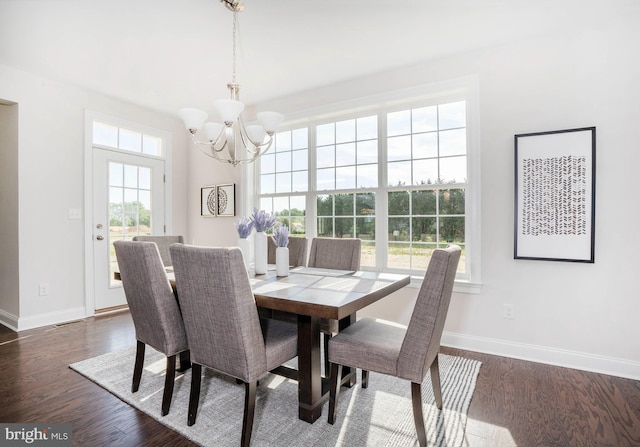 dining space featuring dark hardwood / wood-style flooring and a chandelier