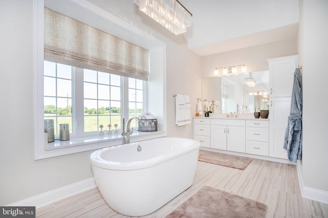 bathroom with a bathing tub and vanity