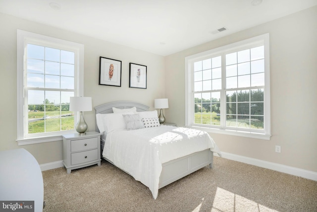 bedroom featuring light colored carpet