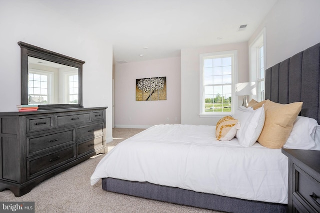 bedroom featuring light colored carpet