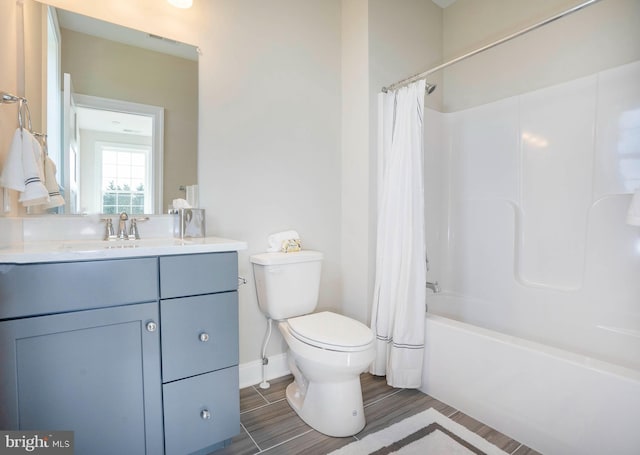 full bathroom featuring shower / bath combination with curtain, vanity, and toilet